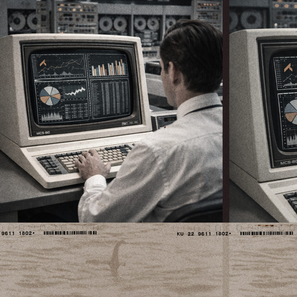 Man typing on an old computer terminal